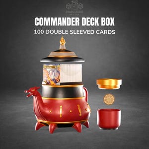 May include: A red and gold Commander deck box with a dragon-shaped spout, holding 100 double-sleeved cards. The box has a decorative lid and a separate gold-colored lid and base. The text "Commander Deck Box" is visible.