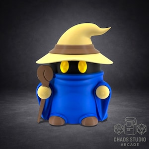 May include: A stylized figurine of a mage character, featuring a black head, yellow eyes, and a blue robe. The mage wears a yellow hat with a brown brim and holds a brown staff. The base of the figurine is brown. The image includes the text "CHAOS STUDIO ARCADE".