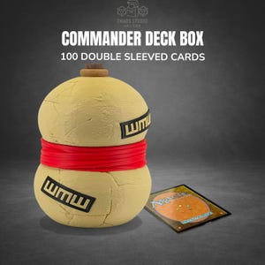 May include: A Commander Deck Box in a unique, spherical design. The box is primarily yellow with a red band and black text. The text on the box reads "Commander Deck Box 100 Double Sleeved Cards". A Magic card is visible.