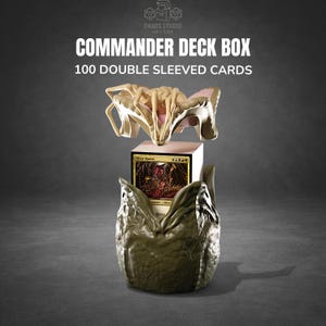 May include: A Commander deck box with a unique design, holding 100 double-sleeved cards. The box is olive green with a beige and pink accent. The text "COMMANDER DECK BOX" and "100 DOUBLE SLEEVED CARDS" are displayed on the top.