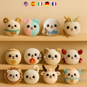 May include: A selection of handmade crochet zodiac signs, each with distinct characteristics. The signs include Aries, Gemini, Cancer, Leo, and others. Each sphere is approximately 7.6 cm in diameter, made with cream-colored yarn, and decorated with colourful accents.
