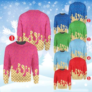 Op de afbeelding: Een collectie truien met lange mouwen in verschillende kleuren, waaronder roze, blauw, groen en rood. Elke trui heeft een textuurpatroon en een wafelontwerp met druipend ijs.