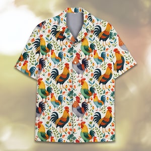 May include: Short-sleeved button-down shirt with a repeating rooster pattern. The roosters are in various colors, including yellow, orange, blue, and green, set against a white background with floral and leaf accents. The shirt has a classic collar and a relaxed fit.