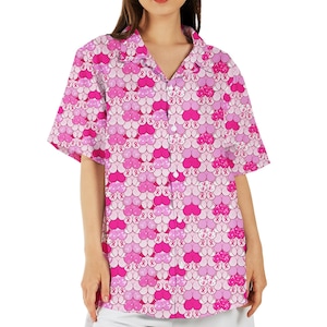 May include: Pink and white short-sleeved button-down shirt with a pattern of pink ribbons and hearts.