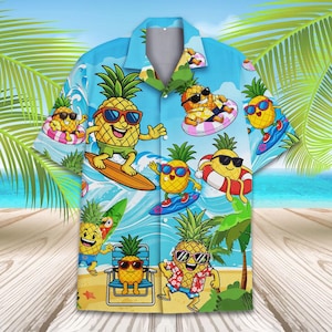 May include: A light blue Hawaiian shirt featuring a repeating pattern of anthropomorphic pineapples wearing sunglasses and enjoying various beach activities, including surfing and floating on inflatable rings. The shirt has a classic collar and button-down front.