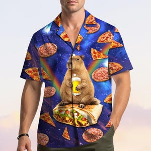 May include: Short-sleeved button-down shirt with a whimsical design. The shirt features a blue background with pizza slices and a rainbow. A capybara holding a beer sits on a burrito. The shirt has a classic collar and a relaxed fit.