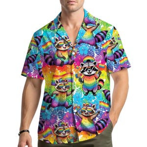 May include: A short-sleeved button-down shirt featuring a vibrant, colorful pattern of cartoon raccoons wearing sunglasses and holding rainbow flags. The shirt's background is filled with tropical flowers in shades of blue, purple, and yellow.