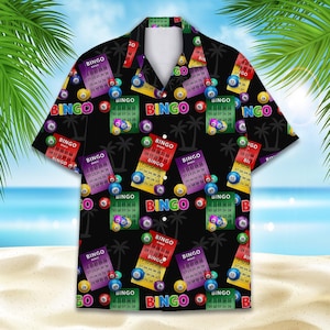 May include: Black button-up shirt with a repeating pattern of bingo cards, bingo balls, and palm trees. The bingo cards are red, green, purple, and yellow, with the word "BINGO" in large letters.