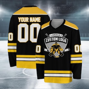 May include: Black and gold hockey jersey with white stripes. The jersey features a custom logo with a hockey player and the text "America Custom Logo". The back of the jersey has the text "Your Name" and the number "00".