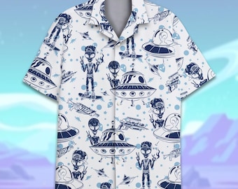 May include: A white button-up shirt with a short sleeve design featuring a repeating pattern of blue alien figures and flying saucers. The aliens are wearing hats and holding peace signs.