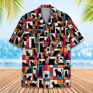 May include: A short-sleeved button-up shirt with a colorful geometric pattern featuring black cats and coffee cups.
