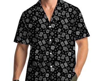 May include: Black button-down shirt with a repeating pattern of playing cards in shades of gray. The short-sleeved shirt has a classic collar and is worn by a person.
