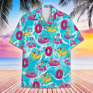 May include: Short-sleeved button-down shirt with a repeating pattern of skeleton figures in inner tubes and pool floats on a turquoise background. The skeletons wear hats and hold drinks. The shirt has a white collar and buttons.