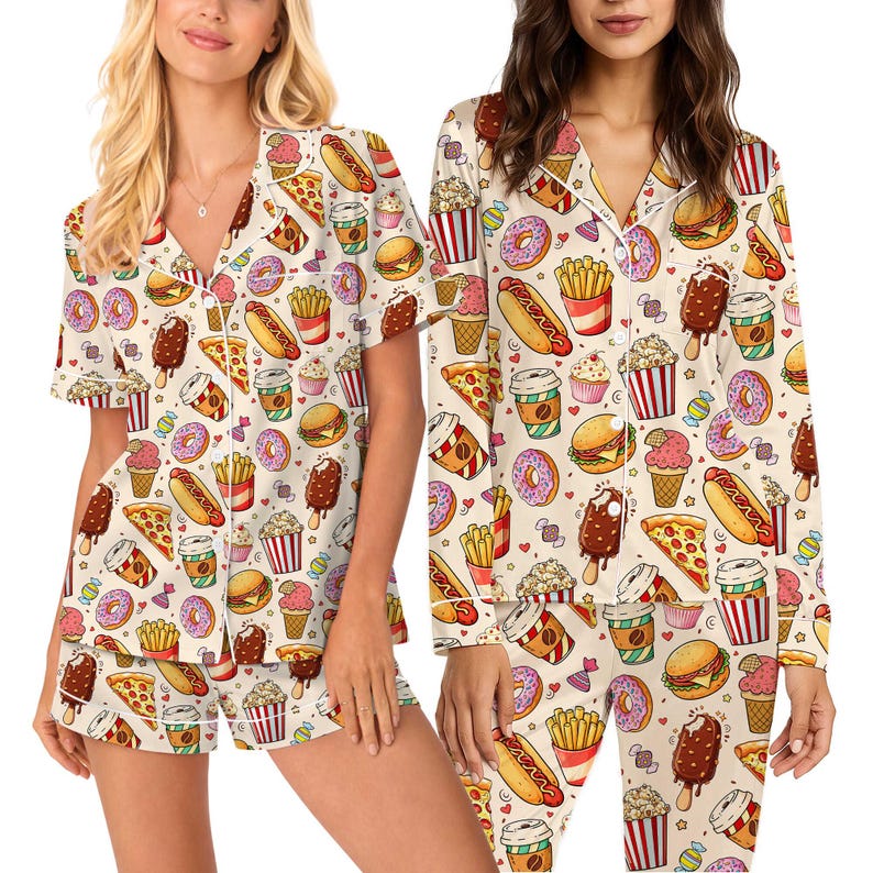 May include: Cream-coloured pyjama set featuring a repeating pattern of fast food items. The pattern includes pizza slices, burgers, ice cream, donuts, and coffee cups. The set includes a short-sleeved top and shorts.