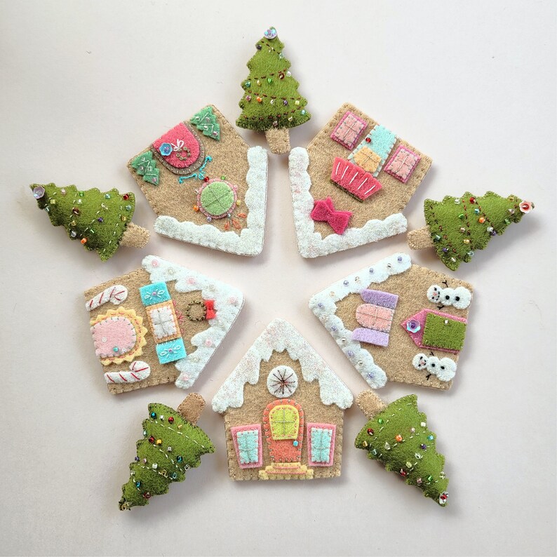 May include: Nine felt ornaments in the shape of gingerbread houses and Christmas trees. The ornaments are decorated with colorful details and beads.