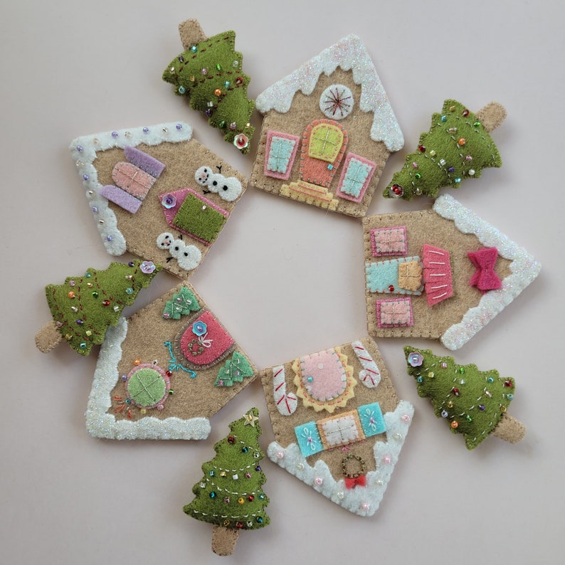 May include: A set of felt Christmas ornaments featuring gingerbread houses and Christmas trees. The houses are decorated with glitter, candy canes, and bows. The trees are decorated with green and red beads.
