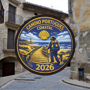 May include: A round patch with the text "CAMINO PORTUGUES COASTAL 2026" in yellow. The patch features an illustration of a person walking on a wooden path towards a lighthouse and the ocean. The background is blue and yellow.