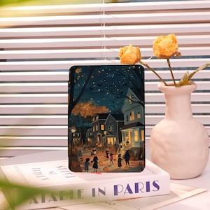 May include: A digital illustration of a neighborhood street scene at night with a group of children trick-or-treating on Halloween. The houses are lit up with warm yellow lights and there are bats flying in the night sky.
