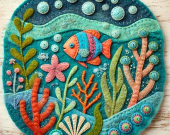 May include: A felt wall hanging depicting an underwater scene with a colorful fish, coral, seaweed, and bubbles. The background is a teal blue color.