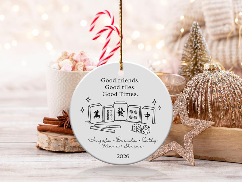 Round ceramic ornament with Mahjong tiles, dice, names, and "Good friends. Good tiles. Good Times. 2026".