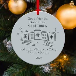 Round ornament with mahjong tiles, dice, names, and "Good friends. Good tiles. Good Times. 2026."