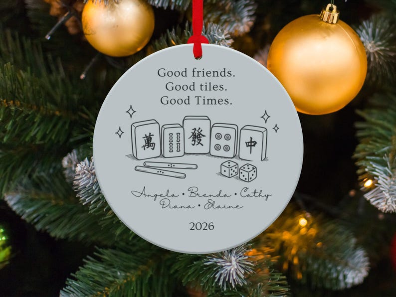 Round ornament with mahjong tiles, dice, names, and "Good friends. Good tiles. Good Times. 2026."