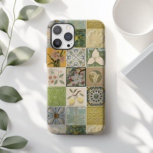 May include: A phone case featuring a mosaic design of floral and geometric tiles in shades of green, yellow, and cream. The case has a glossy finish and a camera cutout.