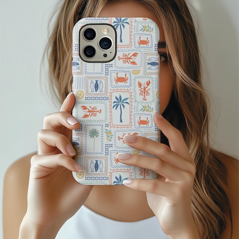 May include: A white phone case featuring a repeating pattern of postage stamp-style illustrations. The stamps depict palm trees, crabs, lobsters, fish, and lemons in shades of blue, orange, and green. The case has a glossy finish and a camera cutout.