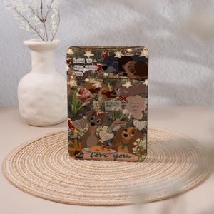 May include: A rectangular phone case featuring a collage of images from the Disney movie, Lady and the Tramp. The case has a floral background with the words "I told the Stars about You" and "love you".