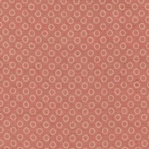 May include: A close-up of a coral-colored fabric with a repeating pattern of small, light-colored circles. The circles are evenly spaced across the fabric, creating a textured appearance. The fabric is likely cotton or a similar material, suitable for quilting or sewing projects.