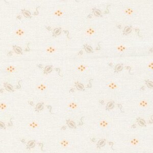 May include: Cream-colored fabric with a repeating pattern of small, stylized floral and dot motifs. The floral elements are in a muted beige, while the dots are a warm orange. The fabric has a subtle, textured appearance.