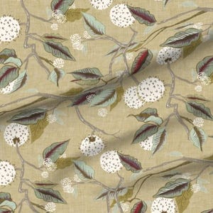 May include: Fabric with a botanical pattern featuring white, spherical flower clusters, green and burgundy leaves, and gray branches on a tan background. The design is repeated across the fabric.