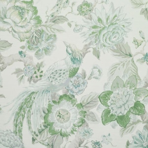 May include: A white background with a green and blue floral pattern. The pattern features a bird with a long tail, flowers, and leaves.