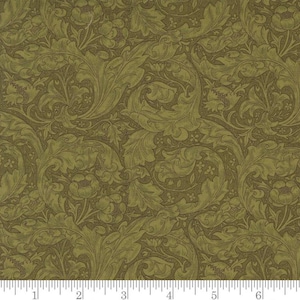 May include: A green and brown floral fabric with a repeating pattern of stylized leaves and flowers. The fabric has a textured surface.
