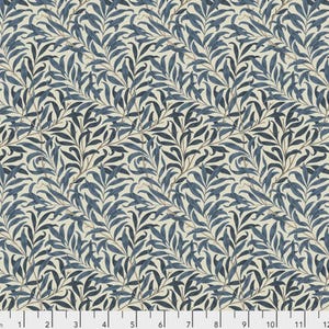 May include: A fabric with a repeating pattern of blue willow leaves and branches on a cream background. The leaves are a deep blue, and the branches are a light brown. The design is a classic, nature-inspired pattern.