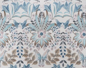 May include: A white fabric with a blue and brown floral pattern. The pattern features stylized flowers, leaves, and birds.