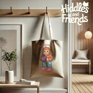 May include: A beige tote bag with a cartoon illustration of a brown Bigfoot wearing blue pajamas with stars and holding a purple mug with a crescent moon. The text "Caffeine and Cryptid" is printed on the bag.