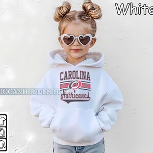 May include: White hooded sweatshirt with a Carolina Hurricanes logo and the text "Carolina" and "Hurricanes".