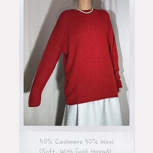 May include: A red sweater with gold thread, made of 50% cashmere and 50% wool. The sweater has long sleeves and a round neckline. The text on the image reads: 50% Cashmere 50% Wool (Soft, With Gold thread).