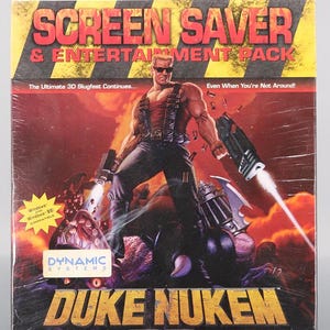 May include: A sealed box for the video game "Duke Nukem 3D" featuring a muscular character with sunglasses and guns. The box has the text "SCREEN SAVER & ENTERTAINMENT PACK" and "DUKE NUKEM 3D". The background is red and yellow.