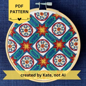 May include: A detailed embroidery pattern in a wooden hoop. The design features a repeating geometric pattern with white squares, blue and green lines, and red and yellow floral accents. The text "PDF PATTERN" is in a yellow banner.