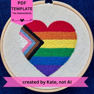 Puede incluir: Corazón bordado en un aro de madera, con un diseño de arcoíris y una sección con los colores de la bandera del Orgullo Progresista. El texto "PDF TEMPLATE *no instructions" está en la parte superior y "created by Kate, not AI" en la inferior.