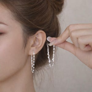 May include: A set of three ceramic mugs with a speckled, matte finish. The mugs are in shades of cream, light brown, and dark brown. Each mug has a simple, minimalist design and a rounded handle.