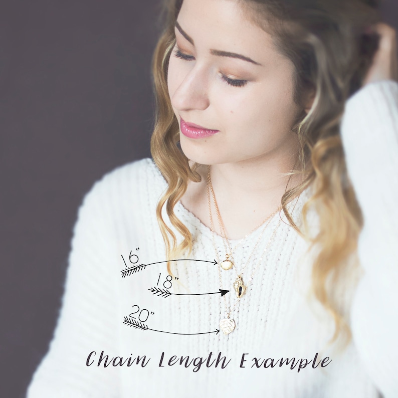 May include: A close-up of a woman wearing a white sweater and a gold necklace. The necklace is shown in three different lengths: 16 inches, 18 inches, and 20 inches. The text "Chain Length Example" is written below the image.