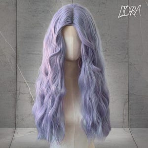 May include: A long, wavy wig in shades of lavender and light purple, displayed on a mannequin head. The wig has a natural-looking part and long, flowing curls. The text "LORA" is visible in the upper right corner.