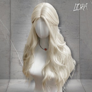 May include: A long, wavy, platinum blonde wig with a center part. The wig is styled with a loose, romantic wave and is worn on a mannequin head.