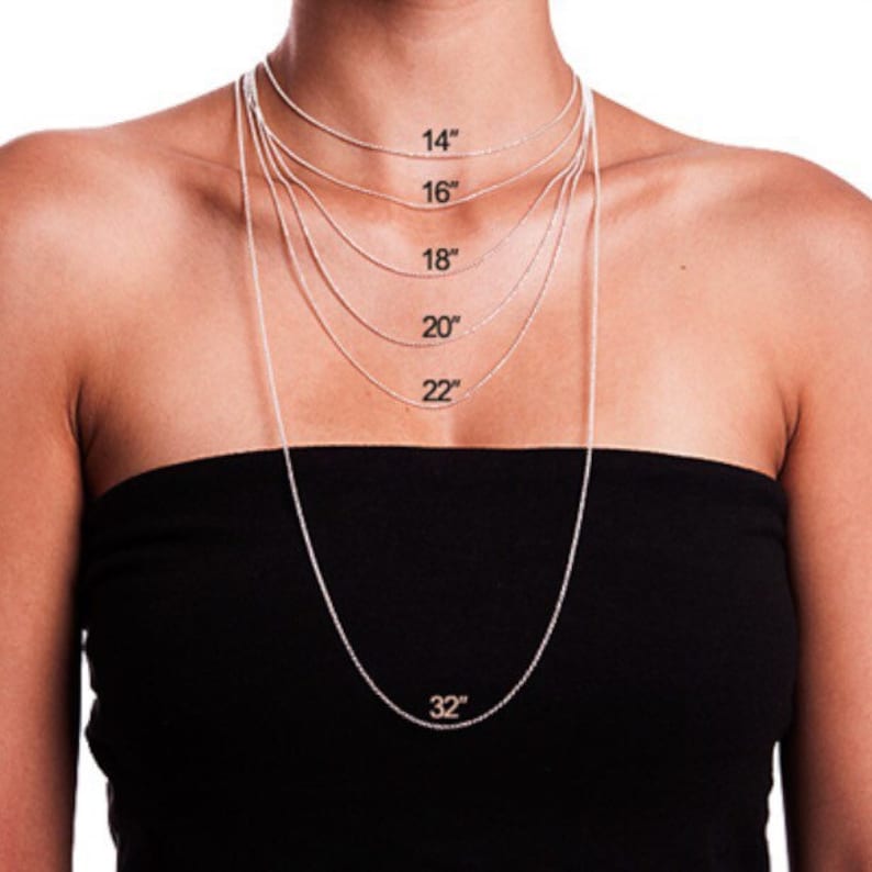 May include: A silver chain necklace with different lengths marked in inches, from 14 inches to 32 inches.