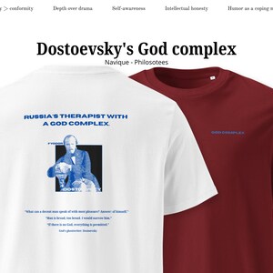 May include: Two t-shirts, one white and one burgundy, are displayed. The white shirt features a blue graphic of a man and text that reads "RUSSIA'S THERAPIST WITH A GOD COMPLEX." The burgundy shirt has "GOD COMPLEX" printed in blue.
