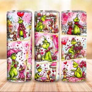 May include: A stainless steel tumbler featuring a collage of illustrations with a green character and dogs in a pink and red Valentine's Day theme. The tumbler has a gold trim and a silver lid.