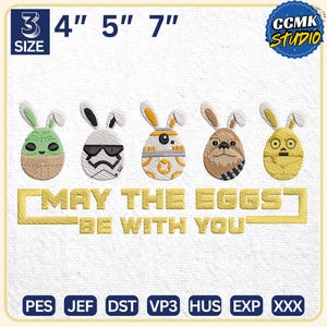 Peut inclure: Broderies de motifs d'œufs de Pâques inspirés de Star Wars. Les œufs sont verts, blancs, orange, marron et jaunes, avec des oreilles de lapin. Le texte dit "MAY THE EGGS BE WITH YOU". Tailles : 7.6, 10.2, 12.7 et 17.8 cm.